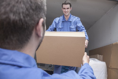 Man with van removal service loading furniture in a London street