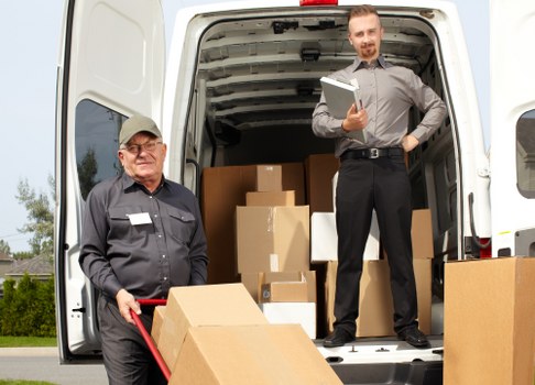 Moving team loading boxes and furniture for a London relocation
