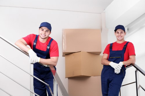 Professional house movers loading furniture for a London home move