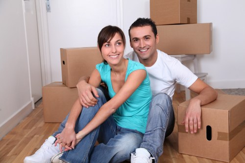 London house removal team transporting boxed belongings and large furniture