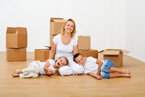 Professional movers loading household items into a removal van in London