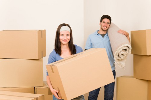 Trained removal staff carrying furniture safely during a move