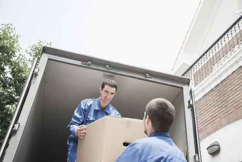 Moving team handling boxes and furniture in a London property