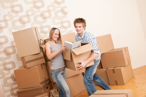 House removals team carrying furniture in a London flat