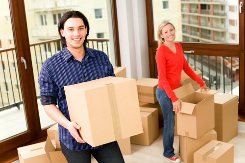 Careful moving of household items in a London flat with stairs